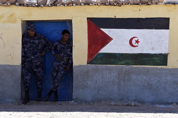 Security men stand next to a mural with the Western Sahara flag at at the Smara refugee camp in Algeria's Tindouf province, home to some several thousands Sahawari refugees, ahead of the 16th edition of the Sahara Marathon, which is organised to demonstrate solidarity with the Saharawi people and to support the independence of the Western Sahara, on February 22, 2016 .
The Western Sahara is a territory bordered by Morocco and Algeria and disputed by Spain and Morocco who both claiming sovereignty.  / AFP / Farouk Batiche        (Photo credit should read FAROUK BATICHE/AFP/Getty Images)