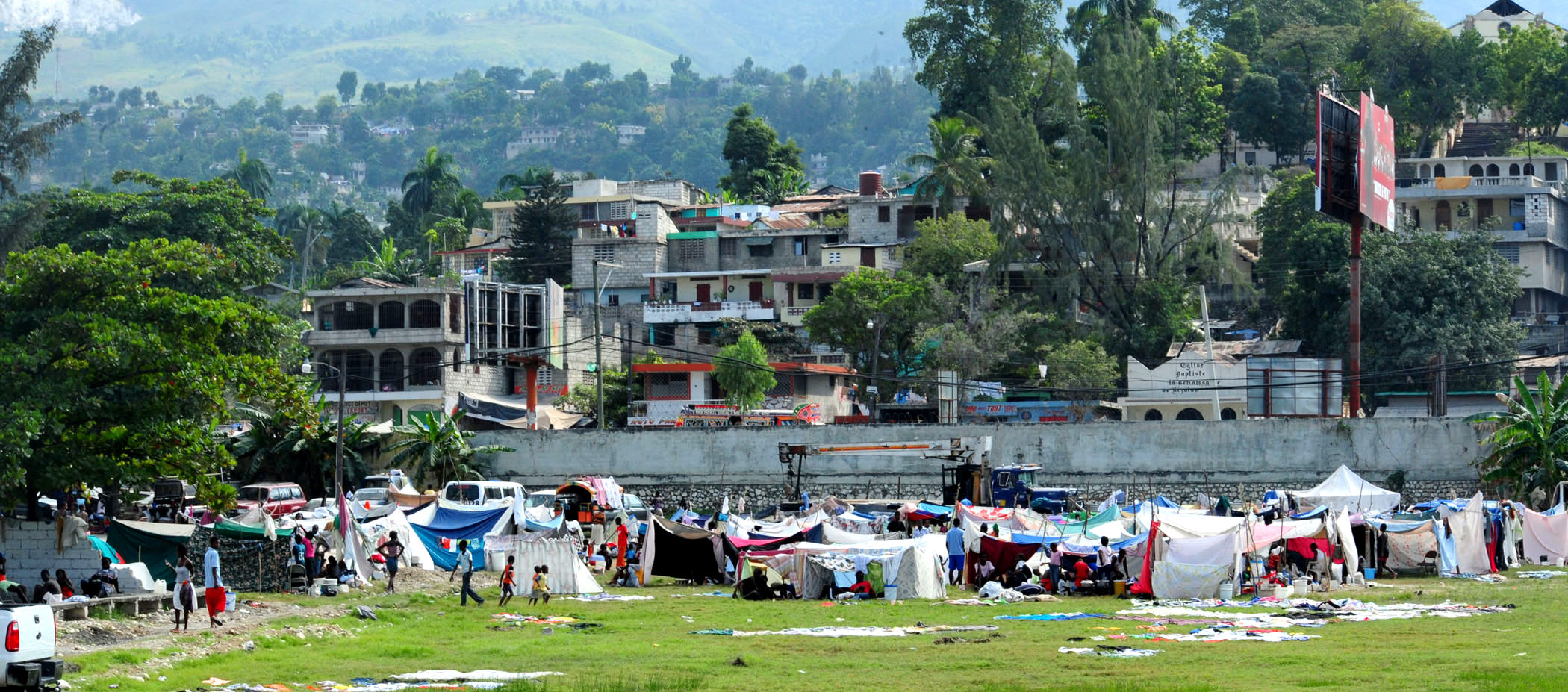PORT-AU-PRINCE, Haiti (Jan. 16, 2010) Haitian earthquake victims in a tent city wait for medical treatment from U.S. Navy and U.S. Coast Guard personnel. Several U.S. military units, including the aircraft carrier USS Carl Vinson (CVN 70) and Carrier Air Wing (CVW) 17 are conducting humanitarian and disaster relief operations as part of Operation Unified Response after a 7.0 magnitude earthquake caused severe damage near Port-au-Prince on Jan. 12, 2010. (U.S. Navy photo by Mass Communication Specialist 2nd Class Adrian White/Released) Public Domain Mark 1.0